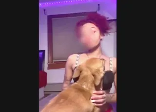 Red-haired ebony dog lover with inked-up pet in zoo clip
